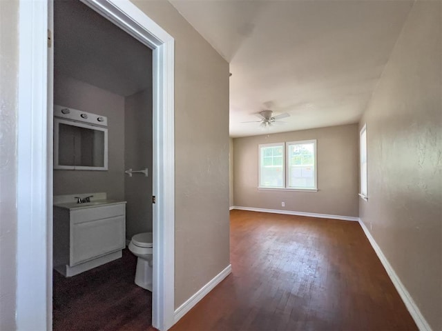 2437 NW 36th Ter, Oklahoma City, OK 73112 - hallway with dark wood-type flooring and baseboards