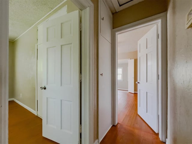 2437 NW 36th Ter, Oklahoma City, OK 73112 - hall featuring wood finished floors and a textured ceiling