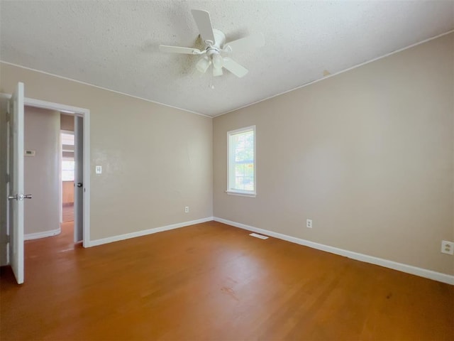2437 NW 36th Ter, Oklahoma City, OK 73112 - spare room with a textured ceiling, wood finished floors, and ceiling fan