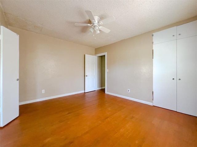 2437 NW 36th Ter, Oklahoma City, OK 73112 - unfurnished bedroom with light wood finished floors, a textured ceiling, a closet, and a ceiling fan