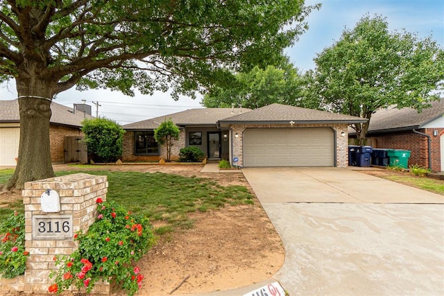 3116 SW 96th St, Oklahoma City, OK 73159 - ranch-style house featuring a garage, driveway, brick siding, and roof with shingles
