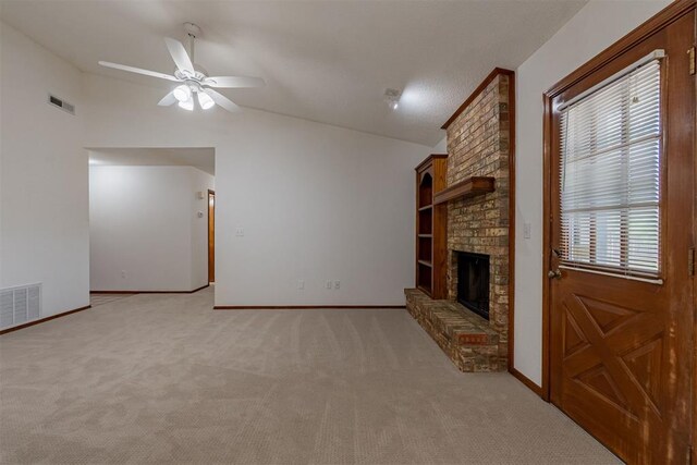 3116 SW 96th St, Oklahoma City, OK 73159 - unfurnished living room featuring vaulted ceiling, light carpet, a brick fireplace, ceiling fan, and built in shelves