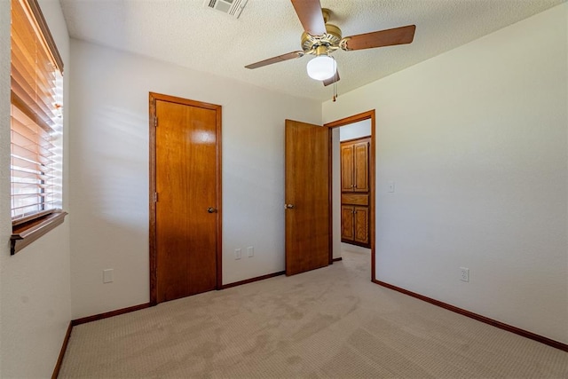 3116 SW 96th St, Oklahoma City, OK 73159 - unfurnished bedroom featuring light colored carpet, a ceiling fan, and a textured ceiling