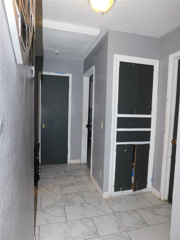 2236 Highland Rd, Oklahoma City, OK 73110 - hallway featuring marble look tiles