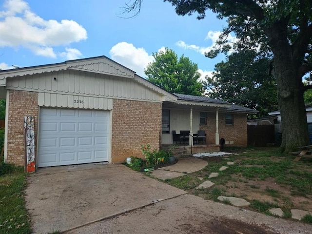 2236 Highland Rd, Oklahoma City, OK 73110 - single story home with brick siding, driveway, an attached garage, and covered porch