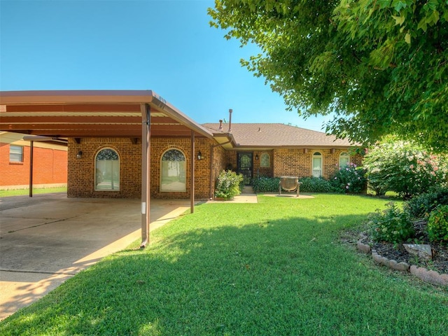 924 Penn Ln, Moore, OK 73160 - ranch-style house with an attached carport, a front yard, brick siding, and driveway