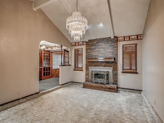 924 Penn Ln, Moore, OK 73160 - unfurnished living room with carpet flooring, a chandelier, and a wood stove