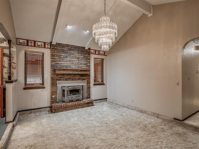 924 Penn Ln, Moore, OK 73160 - unfurnished living room with carpet floors, arched walkways, a chandelier, and a textured ceiling