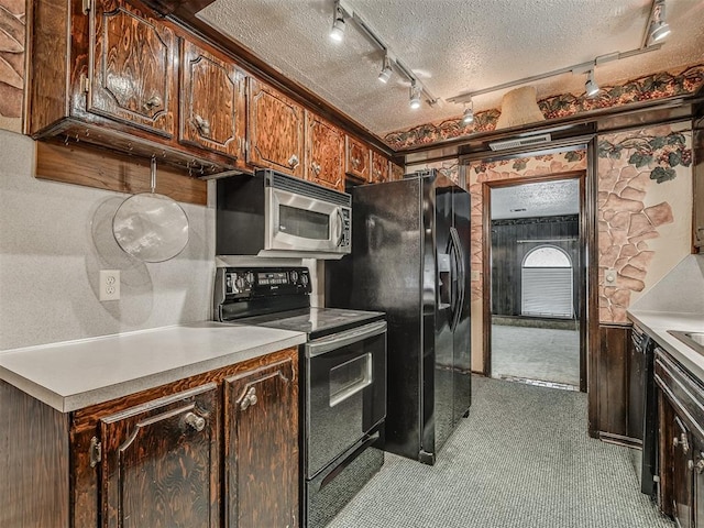 924 Penn Ln, Moore, OK 73160 - kitchen with black appliances, carpet floors, a textured ceiling, track lighting, and light countertops