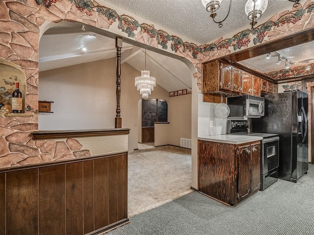 924 Penn Ln, Moore, OK 73160 - kitchen with black appliances, arched walkways, light colored carpet, a textured ceiling, and dark brown cabinetry