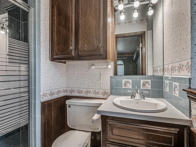 924 Penn Ln, Moore, OK 73160 - bathroom with wallpapered walls, vanity, a wainscoted wall, and a stall shower