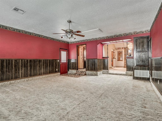 924 Penn Ln, Moore, OK 73160 - empty room with ceiling fan, carpet floors, a textured ceiling, and wainscoting