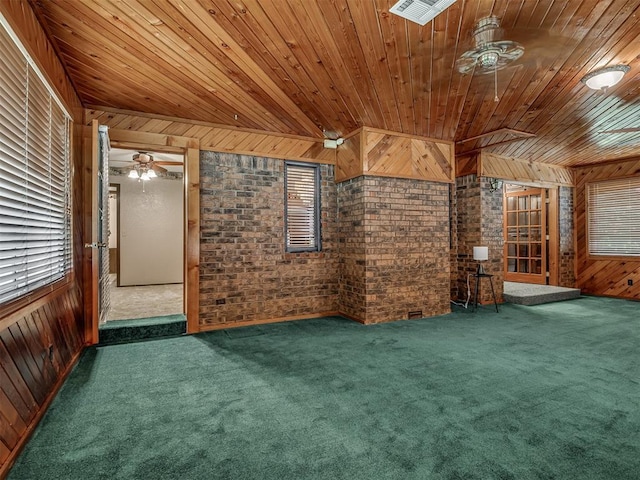 924 Penn Ln, Moore, OK 73160 - unfurnished living room with wood ceiling, wooden walls, a ceiling fan, carpet floors, and brick wall