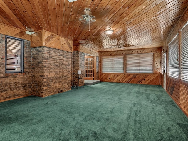 924 Penn Ln, Moore, OK 73160 - carpeted empty room with ceiling fan, wood ceiling, brick wall, and wooden walls
