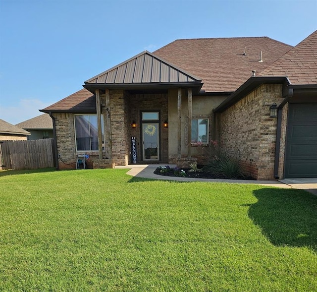 412 E Atlanta Ter, Mustang, OK 73064 - view of front facade featuring brick siding, a shingled roof, and an attached garage