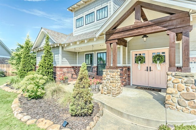 833 Gathering Leaves Way Unit 9183810100, Edmond, OK 73034 - entrance to property with brick siding, a porch, and roof with shingles