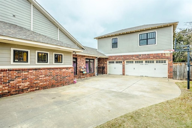 833 Gathering Leaves Way Unit 9183810100, Edmond, OK 73034 - view of front of property featuring a garage, concrete driveway, brick siding, and roof with shingles