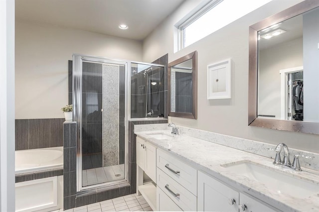 833 Gathering Leaves Way Unit 9183810100, Edmond, OK 73034 - full bathroom featuring a shower stall, double vanity, tile patterned floors, and a bath