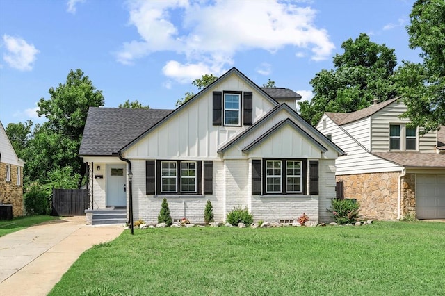 2525 NW 32nd St, Oklahoma City, OK 73112 - view of front of property featuring board and batten siding, driveway, a front lawn, roof with shingles, and brick siding