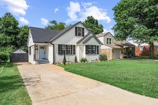 2525 NW 32nd St, Oklahoma City, OK 73112 - view of front of home featuring driveway, roof with shingles, brick siding, board and batten siding, and a garage