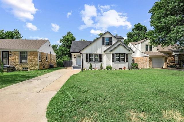 2525 NW 32nd St, Oklahoma City, OK 73112 - view of front of house featuring driveway, a front lawn, board and batten siding, and brick siding