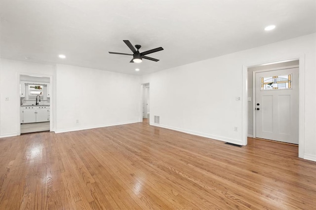 2525 NW 32nd St, Oklahoma City, OK 73112 - unfurnished living room with a ceiling fan, light wood-style flooring, and recessed lighting