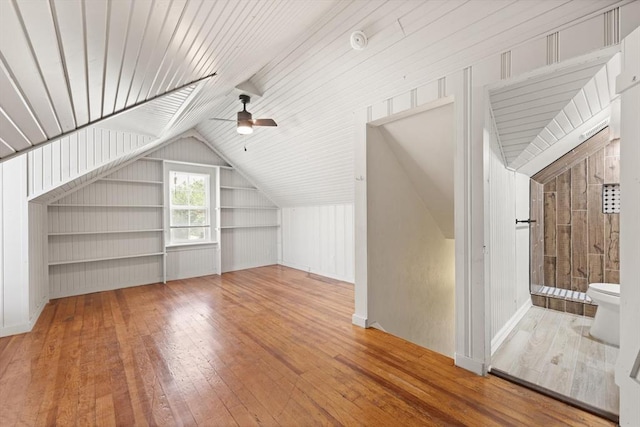 2525 NW 32nd St, Oklahoma City, OK 73112 - additional living space featuring built in shelves, vaulted ceiling, wood-type flooring, and a ceiling fan