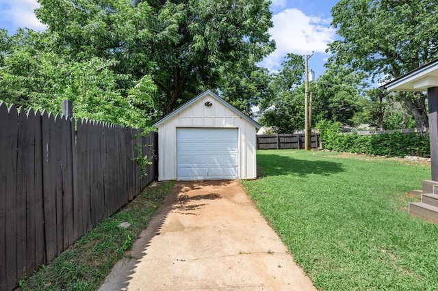2525 NW 32nd St, Oklahoma City, OK 73112 - view of yard featuring concrete driveway, an outbuilding, and a detached garage