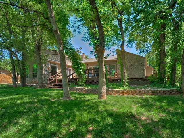 5101 Long Branch Ln, Edmond, OK 73034 - rear view of property with a deck, stone siding, and a yard