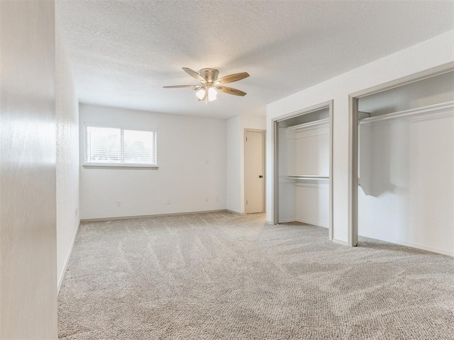 1404 Mary Lee Ln, Edmond, OK 73034 - unfurnished bedroom with multiple closets, carpet, a textured ceiling, and ceiling fan
