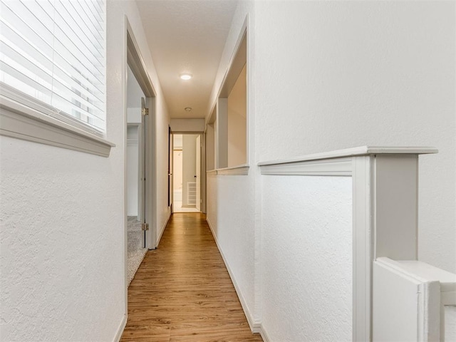 1404 Mary Lee Ln, Edmond, OK 73034 - hallway with a textured wall and wood finished floors