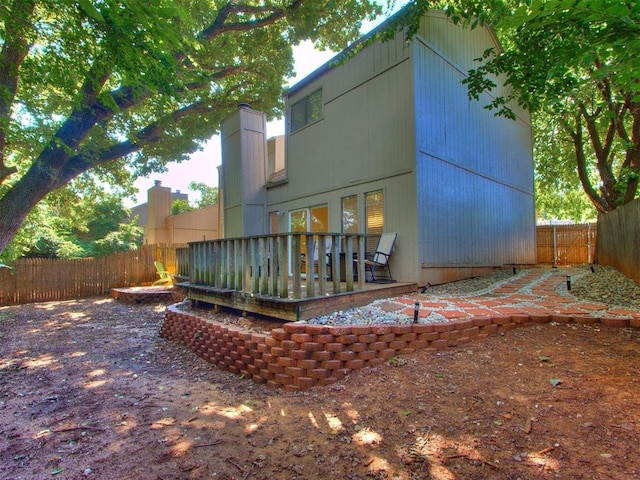 1404 Mary Lee Ln, Edmond, OK 73034 - rear view of house with a fenced backyard, a wooden deck, and a chimney