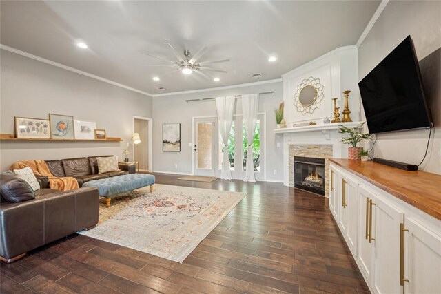 1241 NW 183rd St, Edmond, OK 73012 - living room with ceiling fan, a stone fireplace, crown molding, recessed lighting, and dark wood finished floors