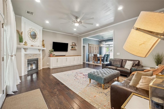 1241 NW 183rd St, Edmond, OK 73012 - living area featuring ornamental molding, dark wood finished floors, a ceiling fan, recessed lighting, and a glass covered fireplace