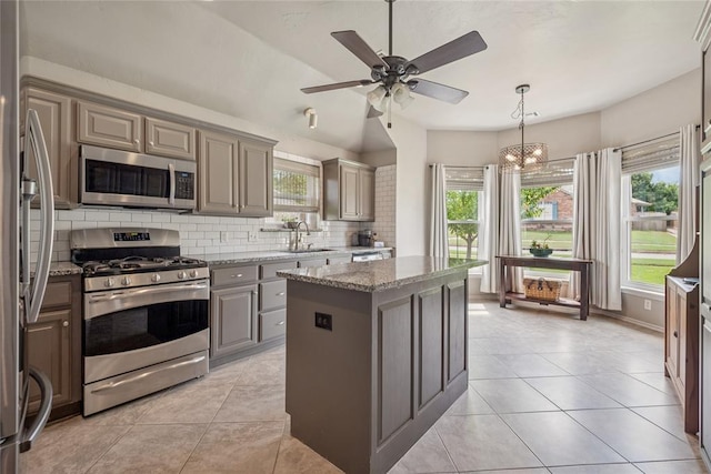 1241 NW 183rd St, Edmond, OK 73012 - kitchen featuring stainless steel appliances, gray cabinetry, decorative backsplash, and healthy amount of natural light