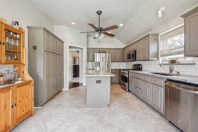 1241 NW 183rd St, Edmond, OK 73012 - kitchen with stainless steel appliances, gray cabinetry, a kitchen island, a ceiling fan, and backsplash