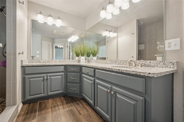 1241 NW 183rd St, Edmond, OK 73012 - bathroom with double vanity, wood finished floors, and tiled shower