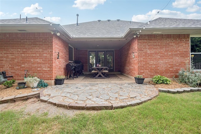 1241 NW 183rd St, Edmond, OK 73012 - rear view of house with brick siding, a shingled roof, and a patio