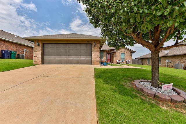 9909 Summerhill Ln, Yukon, OK 73099 - ranch-style home featuring brick siding, a front yard, driveway, and a garage