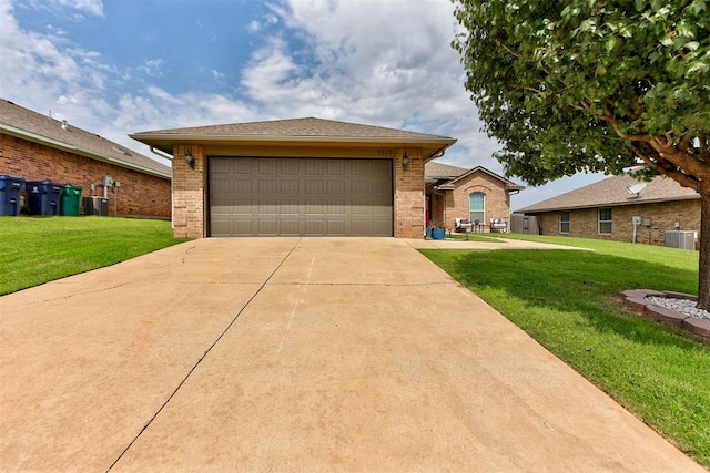 9909 Summerhill Ln, Yukon, OK 73099 - view of front of house featuring a front yard, concrete driveway, brick siding, and an attached garage