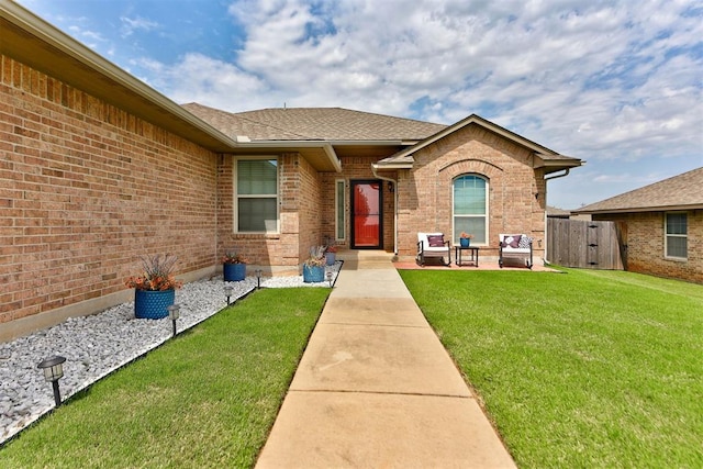 9909 Summerhill Ln, Yukon, OK 73099 - entrance to property with a shingled roof, brick siding, and a gate