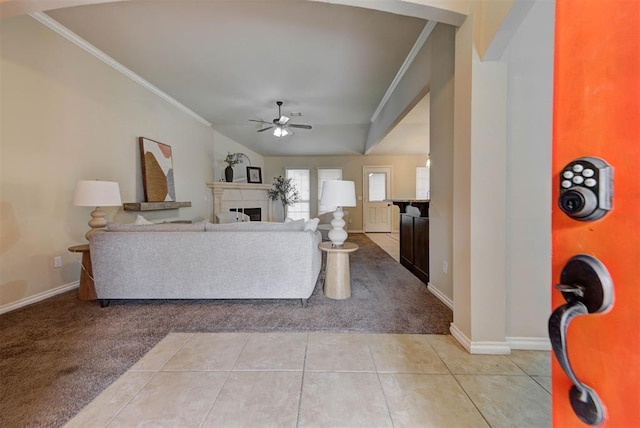 9909 Summerhill Ln, Yukon, OK 73099 - living area with light carpet, a ceiling fan, crown molding, a fireplace, and light tile patterned floors