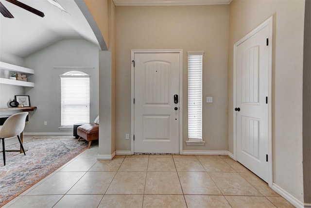 9909 Summerhill Ln, Yukon, OK 73099 - foyer entrance with light tile patterned floors, ceiling fan, arched walkways, and lofted ceiling