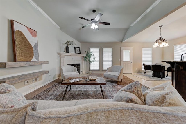 9909 Summerhill Ln, Yukon, OK 73099 - living area with lofted ceiling, a chandelier, ceiling fan, plenty of natural light, and a glass covered fireplace