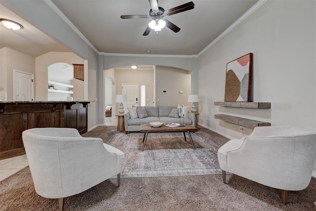 9909 Summerhill Ln, Yukon, OK 73099 - carpeted living room featuring arched walkways, ornamental molding, and a ceiling fan