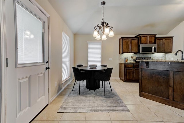 9909 Summerhill Ln, Yukon, OK 73099 - dining area featuring vaulted ceiling, a chandelier, and light tile patterned flooring