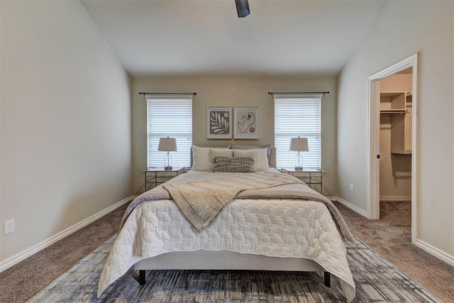 9909 Summerhill Ln, Yukon, OK 73099 - bedroom featuring carpet flooring, multiple windows, a walk in closet, ceiling fan, and lofted ceiling
