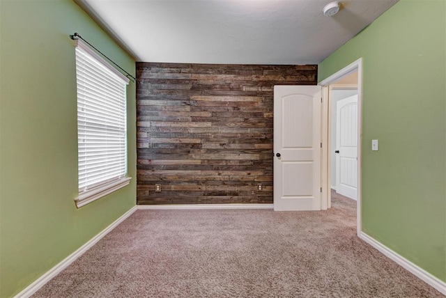 9909 Summerhill Ln, Yukon, OK 73099 - unfurnished room with a smoke detector, healthy amount of natural light, carpet flooring, and wood walls
