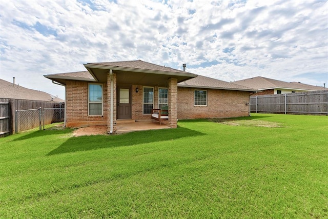 9909 Summerhill Ln, Yukon, OK 73099 - rear view of house featuring a patio, a fenced backyard, and brick siding