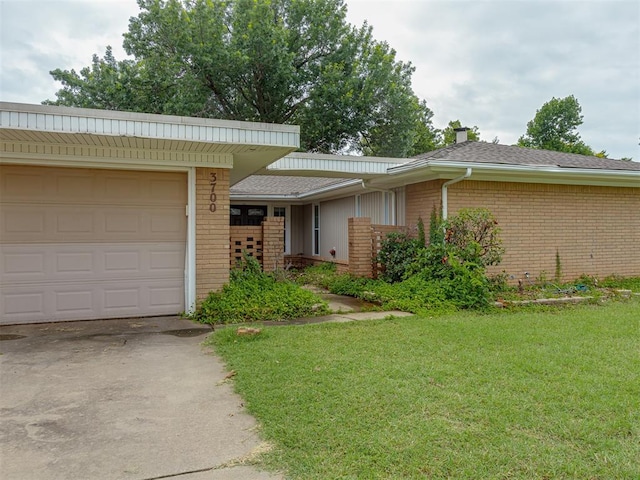 3700 N Edgewater Dr, Oklahoma City, OK 73116 - single story home featuring brick siding, a front yard, a garage, a chimney, and concrete driveway